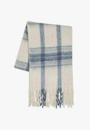 Villainen viltti kermanvärisenä, sinisellä ruutukuviolla. Reunoissa hapsut ja pehmeä tekstuuri. Suorakulmainen muoto, kevyt rakenne.