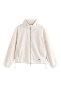 Veste polaire blanche zippée avec col montant, poignets élastiques, cordon de serrage à l’ourlet et petit texte noir "self." sur le bas côté droit devant.