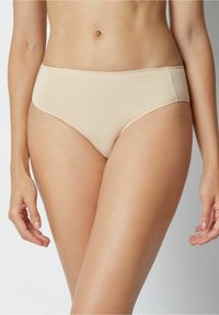 Beige cotton hipster panties with a smooth texture, featuring a mid-rise waist and no visible seams for a seamless look. Stretch fabric for comfort.