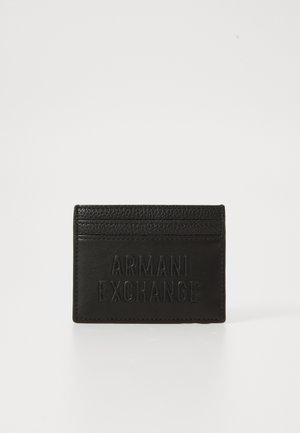Black leather cardholder with three top card slots and embossed "Armani Exchange" logo on front center.