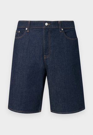 Dunkelblaue Jeansshorts mit geradem Schnitt, fünf Taschen und kontrastierenden goldfarbenen Nähten. Ausgestattet mit Metallknopf und Reißverschluss.