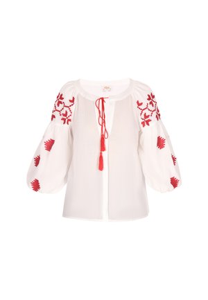 Bijela bluzica s crvenim cvjetnim vezom na napuhanim rukavima, s plaketom sa zatvaranjem na kravatu i resicama. Mekani, strukturirani materijal.