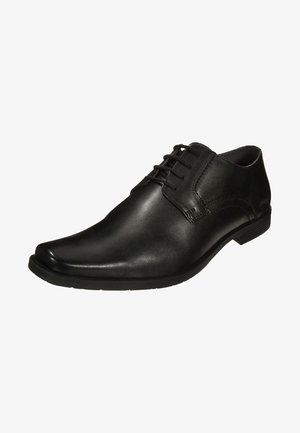 Chaussure formelle pour homme en cuir noir avec lacets et petit talon, présentant une finition lisse et des détails de couture subtils.