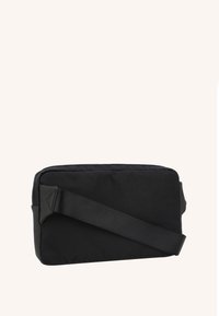 Black fabric shoulder bag with a rectangular shape, a sturdy strap, and matte hardware. Smooth texture with no visible patterns or accents.