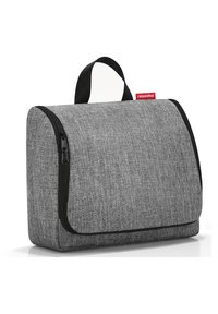 Graue Stoff-Organizer-Tasche mit Überschlagklappe, schwarzem Reißverschluss und einem oberen Griff. Strukturierte Oberfläche mit einfachem, sauberem Design.