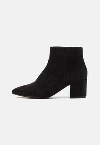 Black suede ankle boots featuring a pointed toe and block heel. The design is sleek with seamless side panels, creating a minimalist look.