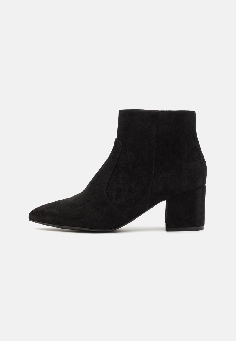 Black suede ankle boots featuring a pointed toe and block heel. The design is sleek with seamless side panels, creating a minimalist look.