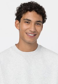Light gray sweatshirt with a crew neckline, textured fabric, subtle logo in white, and ribbed accents at the neck and sleeves.