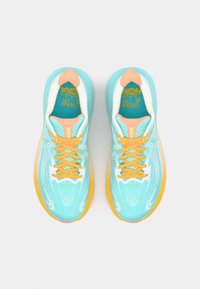 Aqua blue athletic shoes with white accents, orange laces, and a textured surface. Features a light orange heel and a padded tongue.