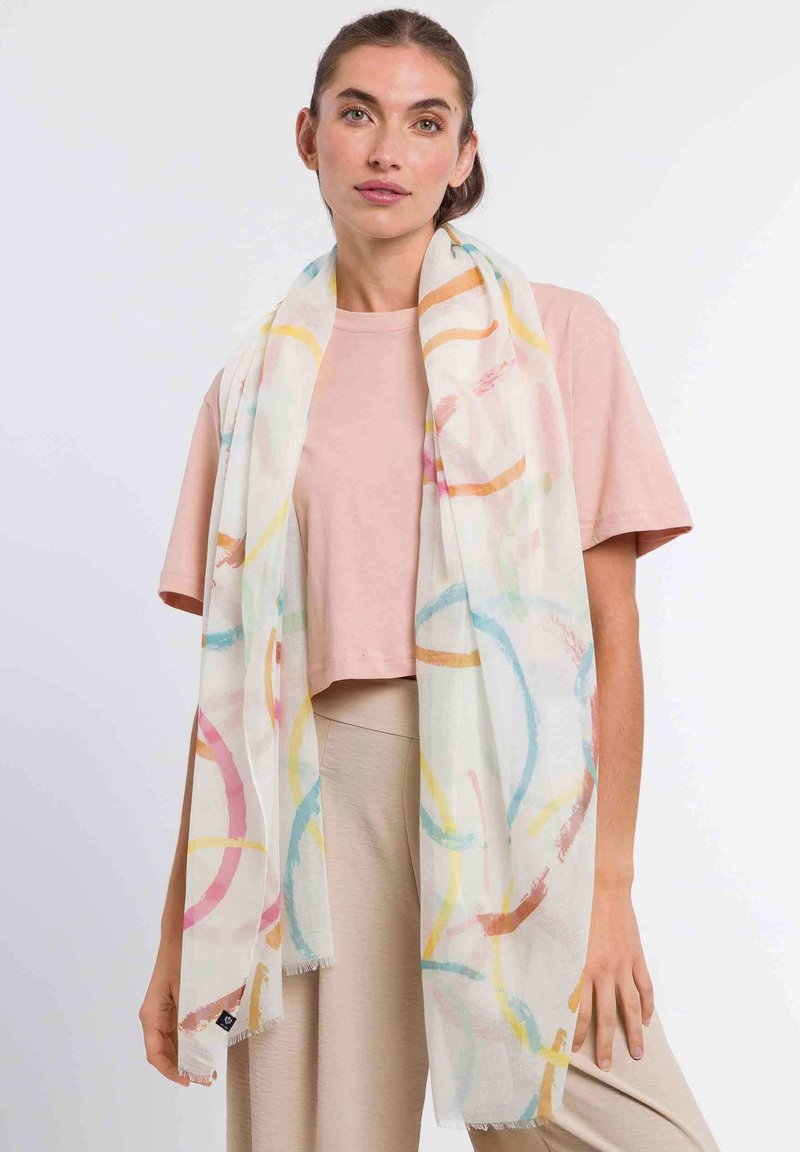 Lightweight, sheer scarf with abstract pastel rings in pink, blue, yellow, and orange. Edges are fringed, enhancing its texture.