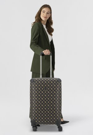 Wheeled suitcase with black fabric featuring a gold geometric pattern, black accent corners, and a retractable silver handle.