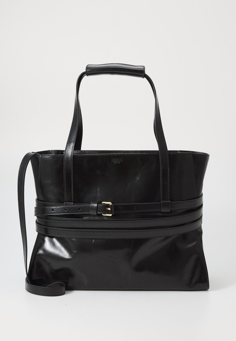 Black leather tote bag with shiny finish, structured shape, two top handles, and a removable shoulder strap. Features gold-tone buckle detail.