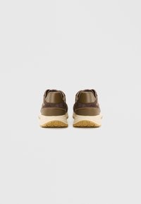 Καφέ αθλητικά παπούτσια με επάνω μέρος από σουέντ, λείο δερμάτινο πίσω πάνελ στη φτέρνα και ελαφριά ταμπά σόλα από καουτσούκ με σχέδιο πέλματος.