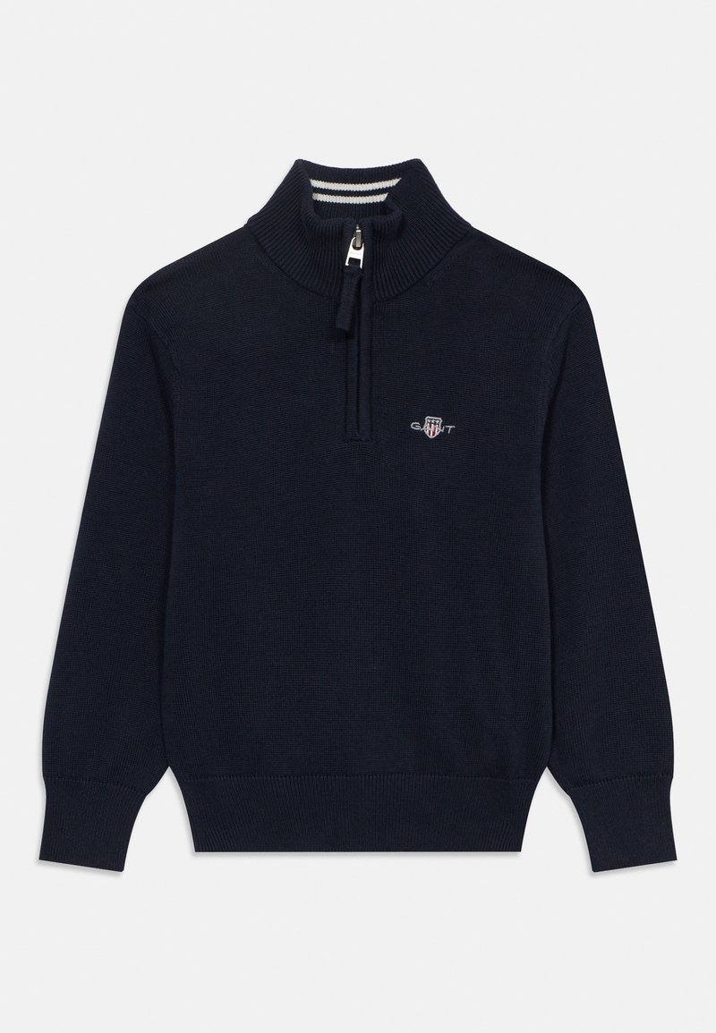 Πλεκτό πουλόβερ σε ναυτικό μπλε χρώμα με ριμπ γιακά, μισό φερμουάρ, μακριά μανίκια και μικρό κεντημένο λογότυπο στο αριστερό στήθος.