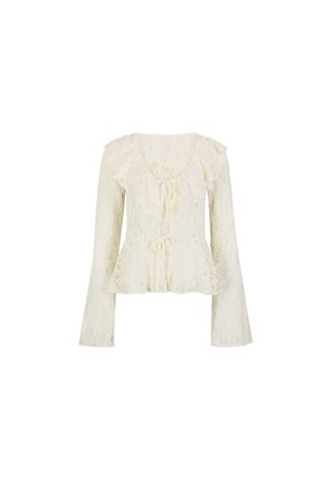 Blusa in pizzo crema con maniche lunghe a campana, scollo arricciato, vita peplum e fiocchi decorativi sul davanti.