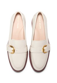 White leather loafers with a gold buckle, rounded toe, and contrasting maroon sole. Smooth texture with subtle stitching detail.