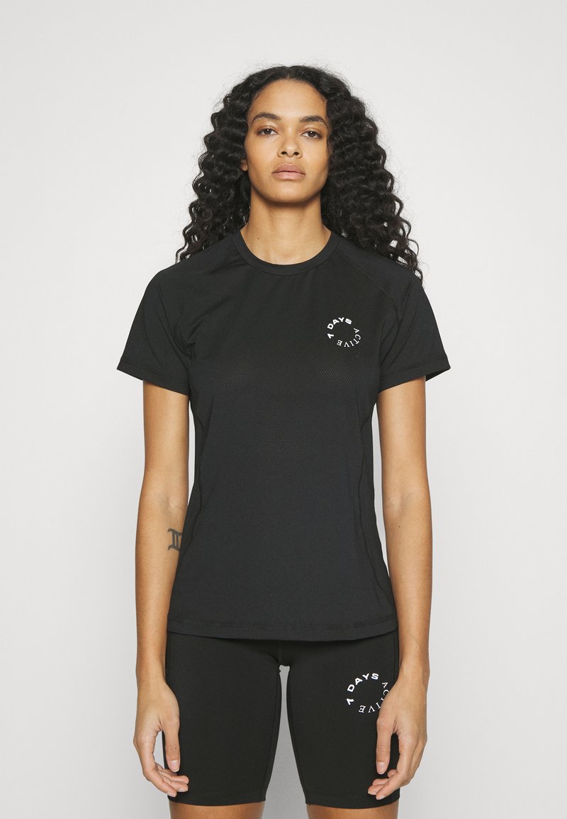 Black athletic t-shirt with short sleeves and a round neckline, featuring a small white logo on the left chest. Smooth, fitted design.
