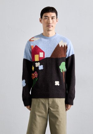 Knit sweater with a blue top half featuring a red house, mountains, green trees, and flowers; dark brown bottom with ribbed hem.