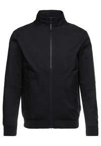 Svart jacka med hög krage, framzip och två sidofickor. Har en texturerad tygkvalitet samt ribbade manschetter och nederkant.