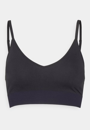 Zwarte bralette met een V-hals, verstelbare bandjes en een contrasterende donkerblauwe elastische band aan de onderkant. Gemaakt van een soepele, rekbare stof.