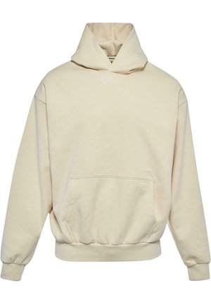 Beige huvtröja med framficka, elastiska muddar och fåll. Har en liten vit logotyp på bröstet. Mjuk, enfärgad tygtextur.