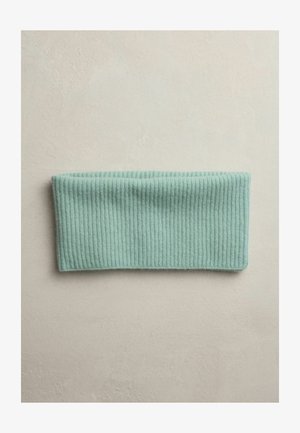 Egy bordázott menta zöld fejpánt laposan elhelyezve egy világos, texturált felületen, bemutatva puha anyagát és szélességét.