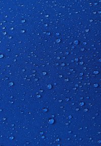 Blue fabric with a textured surface, featuring numerous droplets of water on it, highlighting its waterproof qualities.