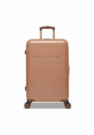 Hard-shell carry-on suitcase in rose gold, featuring a matte finish, embossed brand name, a retractable handle, and four wheels for mobility.