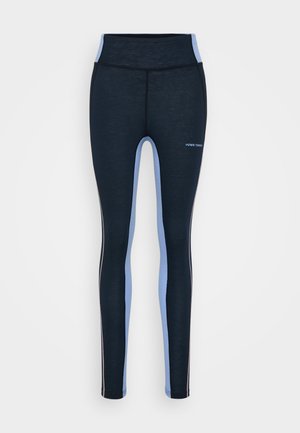 High-waisted, fitted leggings in dark navy with light blue side panels. Made of stretch fabric, featuring a smooth texture and minimal branding.