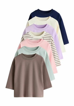 Seven long-sleeve crewneck shirts in brown, light green, pink, striped beige, lavender, cream, and navy blue, arranged overlapping in a fan shape.