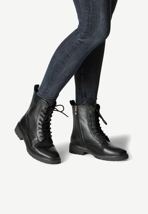Black lace-up ankle boots made of smooth leather, featuring a side zipper, a rugged sole, and reinforced eyelets for durability.
