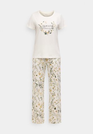 Damski zestaw piżam bawełnianych składający się z kremowej koszulki z krótkim rękawem z nadrukiem kwiatowym oraz dopasowanych spodni w wzór wielokolorowych kwiatów.