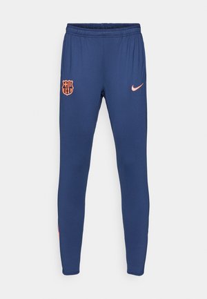 Jūriniai sportiniai treningai, pagaminti iš švelnios audinio su elastinga juosta. Yra Barselonos klubo logotipas ir mažas rožinės spalvos Nike swoosh šonu.