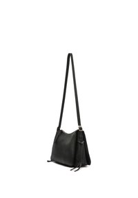 Black leather shoulder bag with long adjustable strap, front zipper detail, and tassel accents on side, shown against white background.