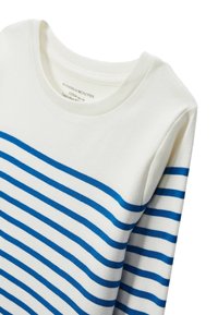 Sweatshirt en coton blanc avec des rayures horizontales bleues, présentant un col rond et des poignets côtelés. Le tissu a une texture lisse.