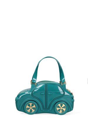 Teal handbag shaped like a compact car with gold-accented wheels, top zipper, and dual shoulder straps against a white background.