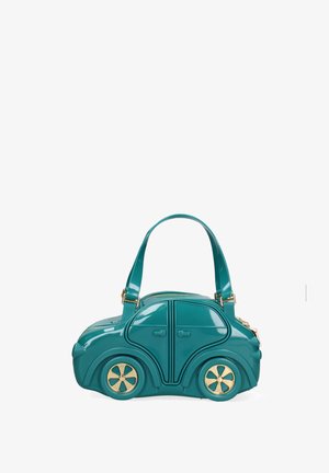 Teal handbag shaped like a compact car with gold-accented wheels, top zipper, and dual shoulder straps against a white background.