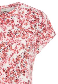 Lyhythihainen valkoinen paita, jossa tiheä vaaleanpunainen ja musta kukkakuvio, pyöreä pääntie ja väljä istuvuus.