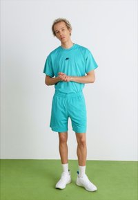 Nike Sportswear Teplákové kalhoty - dusty cactus