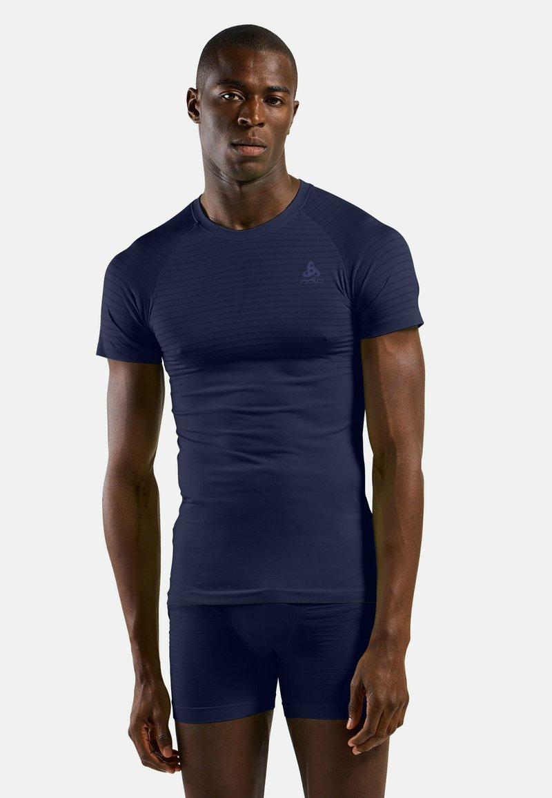 Short-sleeved navy athletic shirt with a textured design, featuring a crew neck and logo on the chest, paired with matching shorts.