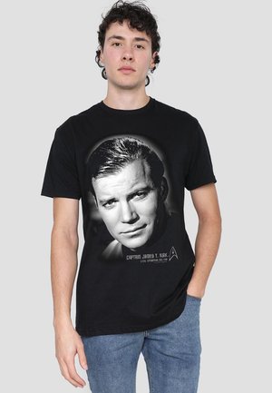 Black cotton t-shirt featuring a black-and-white graphic of a man's portrait, labeled "Captain James T. Kirk" with a Starfleet insignia.
