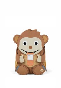 Kinderrucksack in Form eines Affen aus einem beige- und cremefarbenen Stoff, mit runden Ohren, einem lächelnden Gesicht, einem Reißverschlussfach und einem Platz für ein Namensschild.