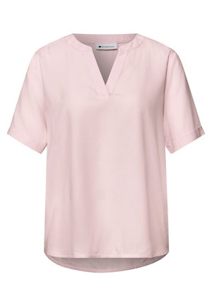 Light pink short-sleeve blouse with notch neckline, relaxed fit, and slight rounded hem, designed for casual or professional wear.