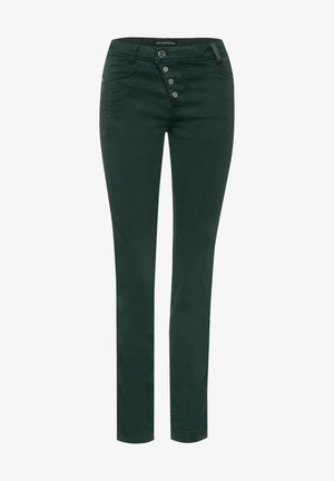 Pantalon vert foncé slim avec quatre boutons asymétriques sur le devant et poches avant, comprenant un détail décoratif de clous sur la poche droite.