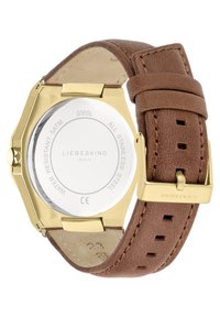 Achtkantiger Uhrenboden aus Edelstahl mit einer glatten silbernen Oberfläche, braunem Lederarmband mit Steppnähten und einer Metallschnalle. Wasserdicht bis 5 ATM.