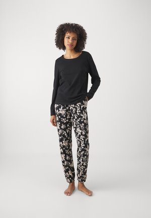 Black long-sleeve top paired with black pants featuring a cream floral pattern. Soft fabric, relaxed fit, and elastic cuffs on pants.