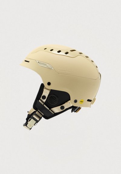 Casco da sci beige con accenti neri, fori di ventilazione, cinghie regolabili e logo MIPS per una maggiore sicurezza. Finitura opaca liscia.