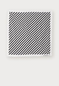 Black and white scarf featuring diagonal stripes. Material is soft with a smooth texture. Brand label at the bottom right corner.