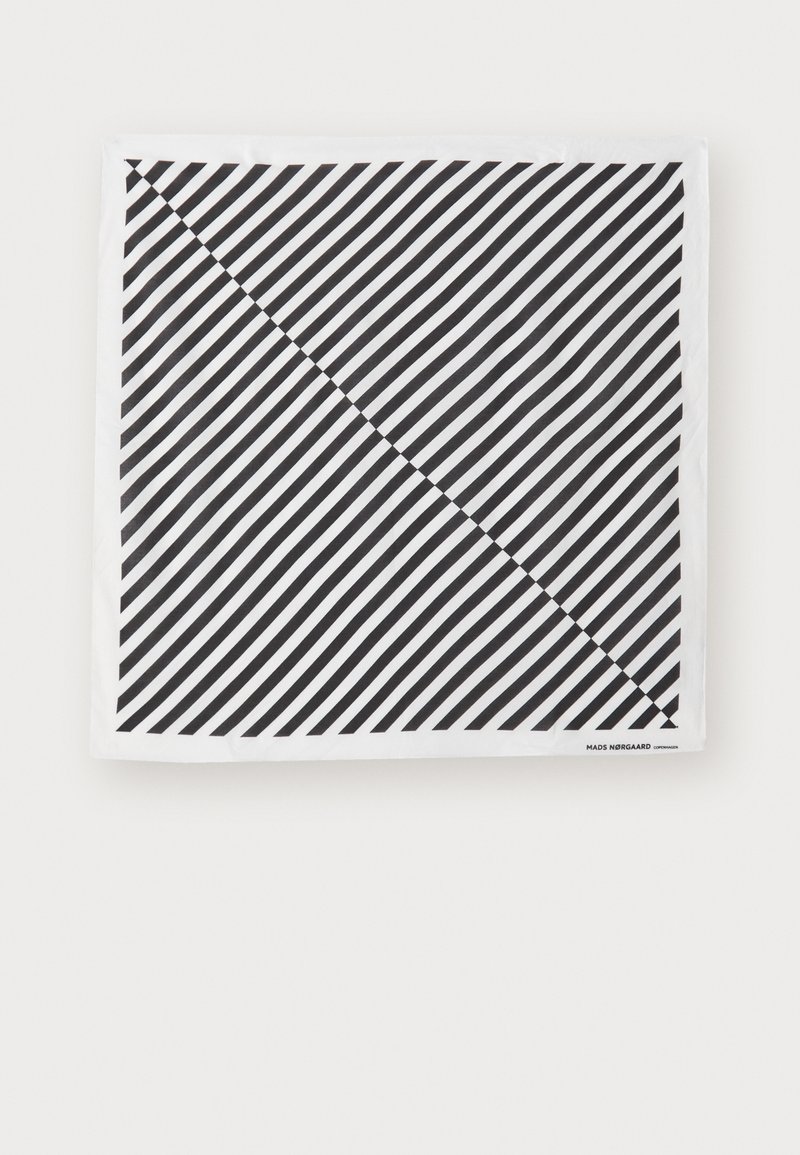 Black and white scarf featuring diagonal stripes. Material is soft with a smooth texture. Brand label at the bottom right corner.
