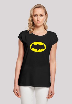 Black t-shirt with a yellow Batman logo on the front. Soft fabric, relaxed fit, short sleeves, and crew neck design.